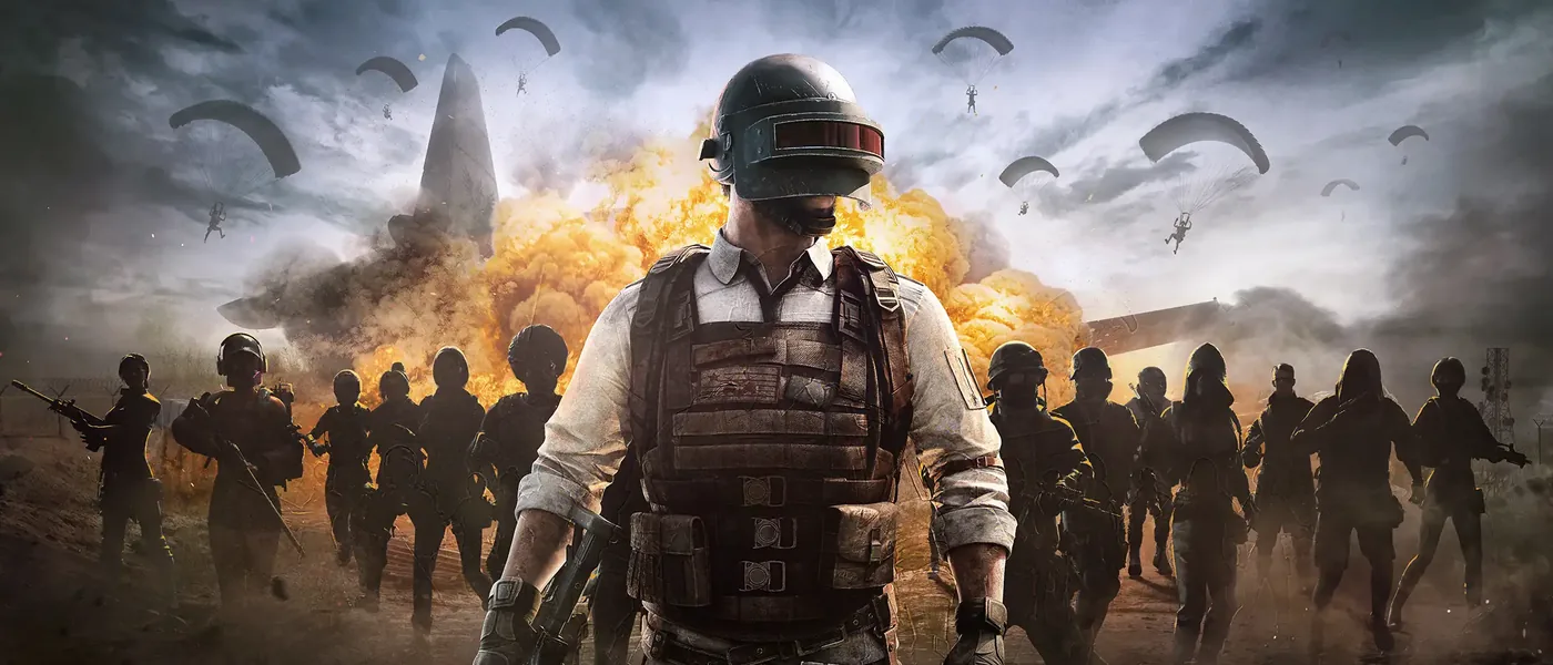 PUBG: BATTLEGROUNDS key art: a soldier in a level 3 helmet in front of his squad, parachutes in the sky
